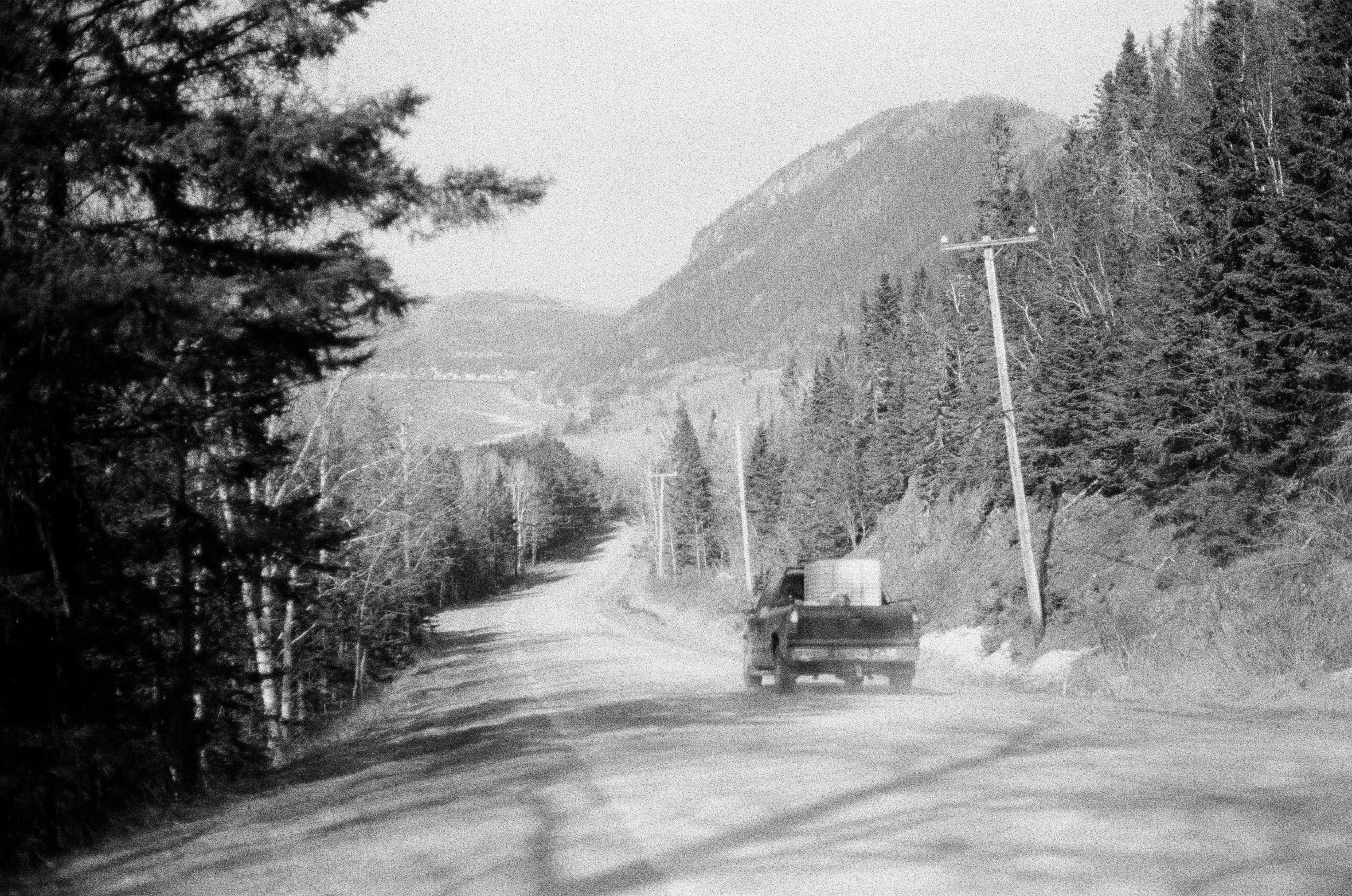 a black and white image of some people riding in a carriage