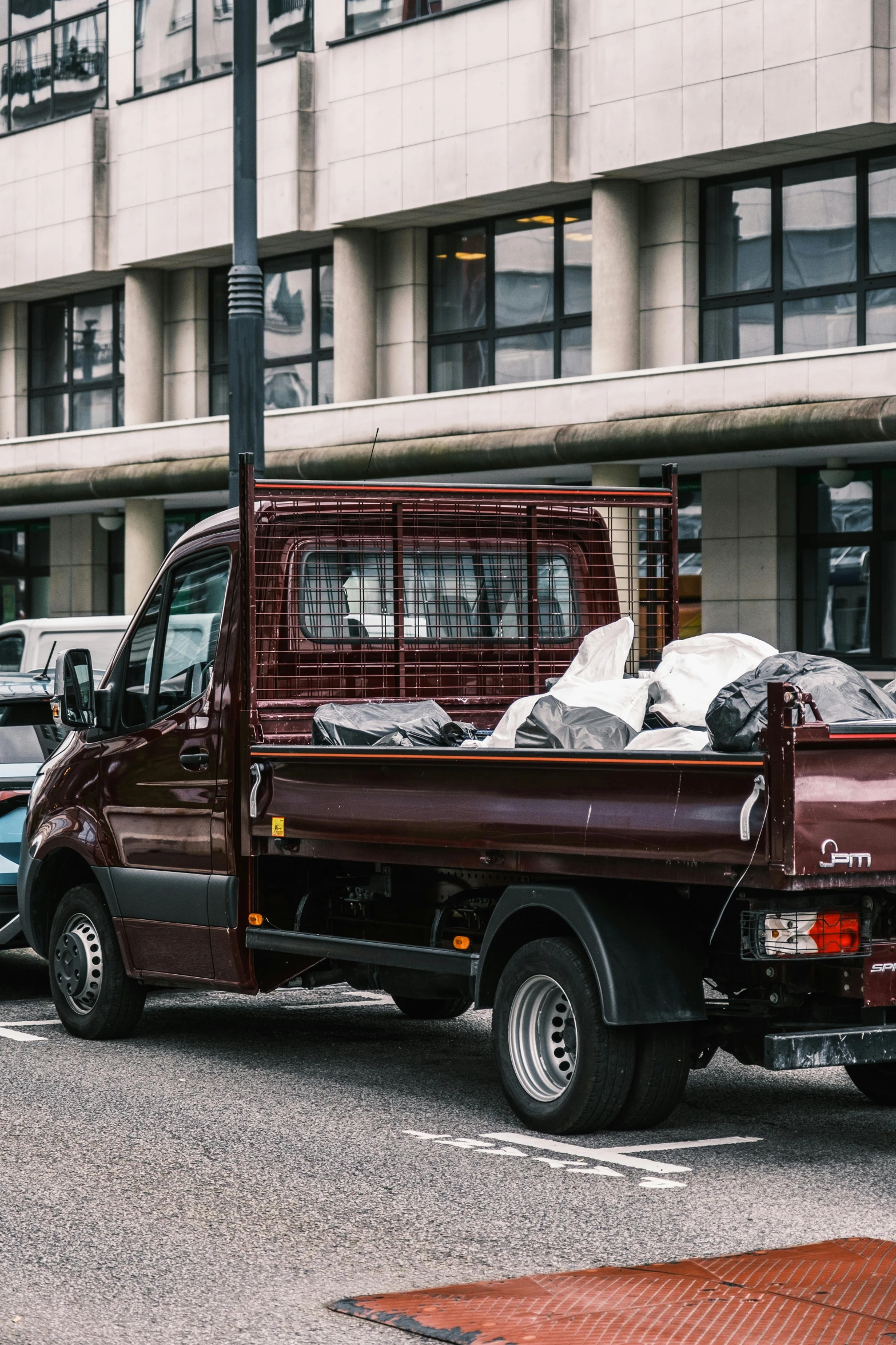 red pick up truck parked next to a building