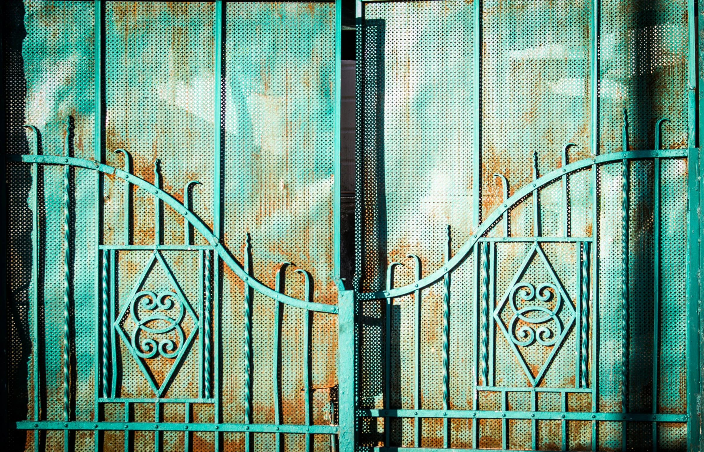 a large blue metal gate with ornate details