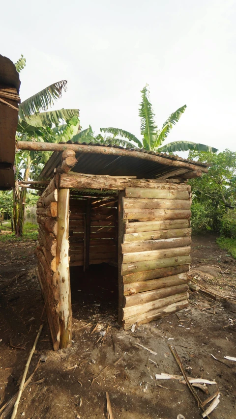 a building with an open door and trees on the side