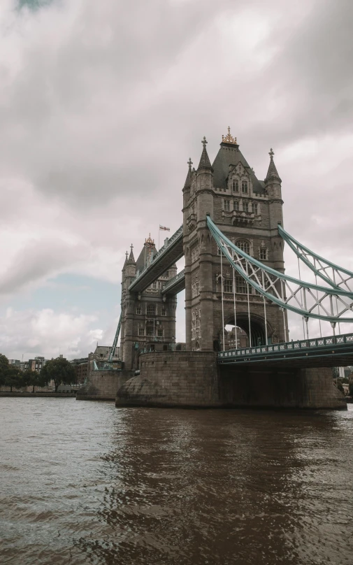 an old bridge with a few buildings sitting in the distance