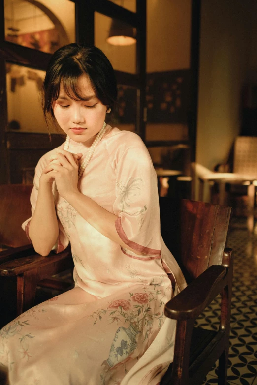 woman in kimono dress sitting in an ornately decorated room