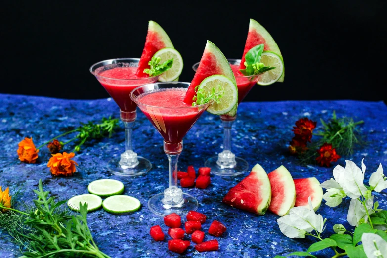 a table topped with fruit and cocktail glasses