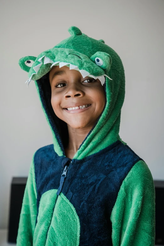  in green hoodie smiling and wearing fish mask