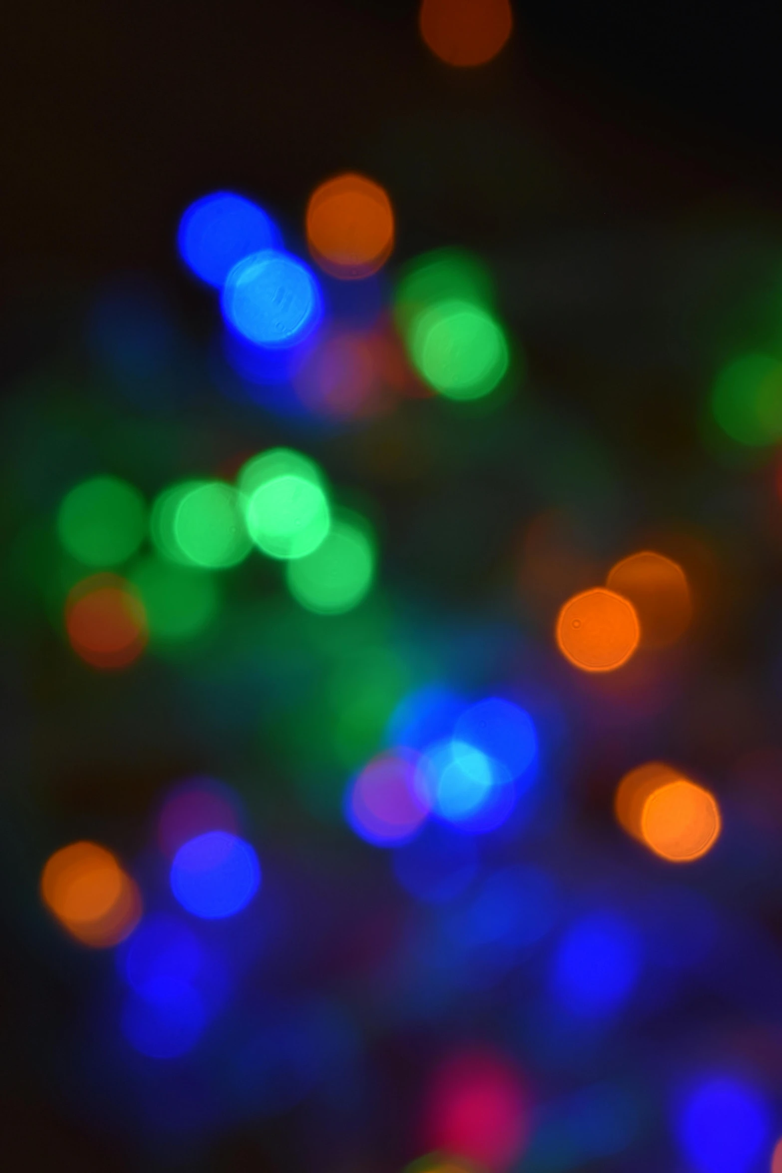 a blurry, colorful light that is on top of a dark background