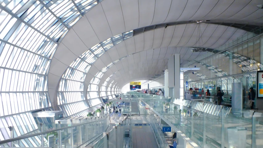 the interior of an airport looking down at glass and metal