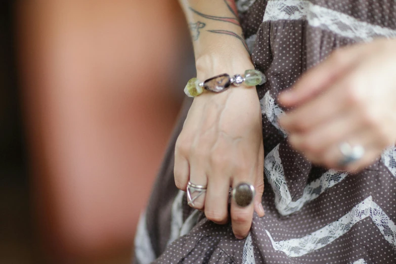 the women is carrying a bag with many different rings on her wrist