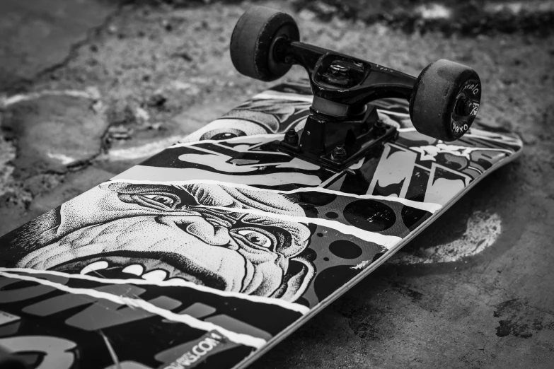 a skateboard with a skull is sitting on the ground