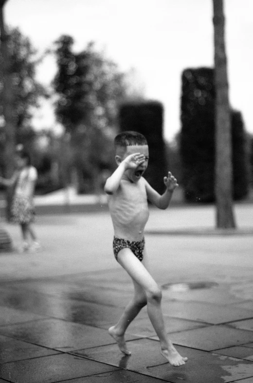 a shirtless  playing on a skateboard in the street