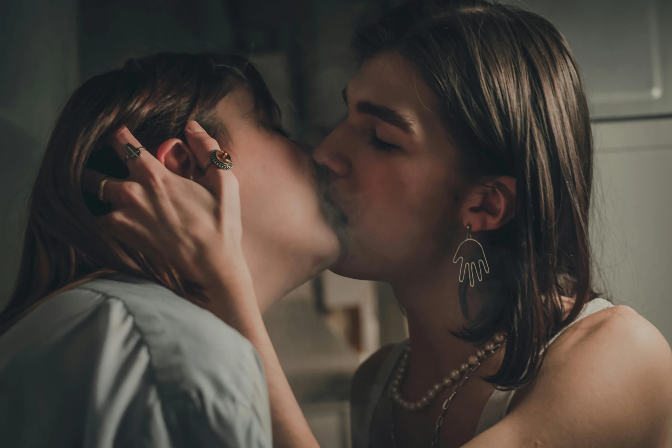 two women kissing each other as they lean in close