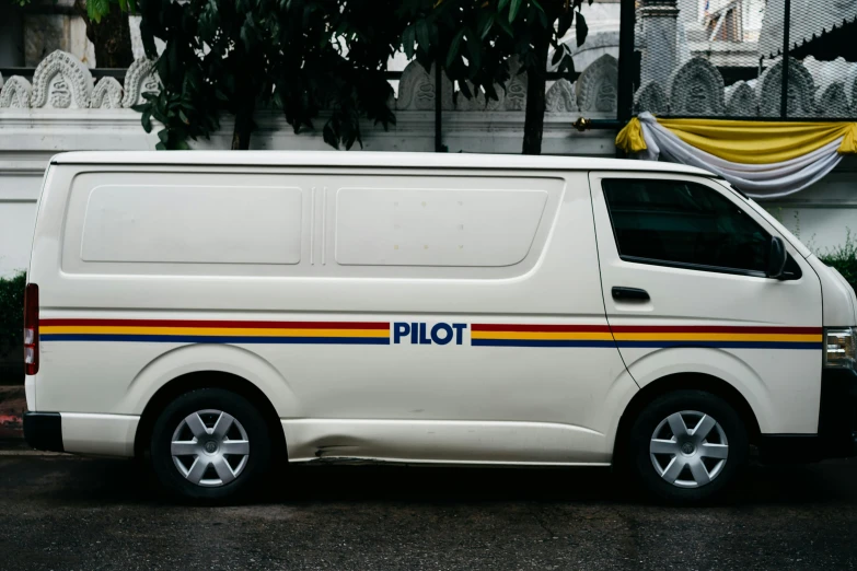 a white police van is parked in front of an old building