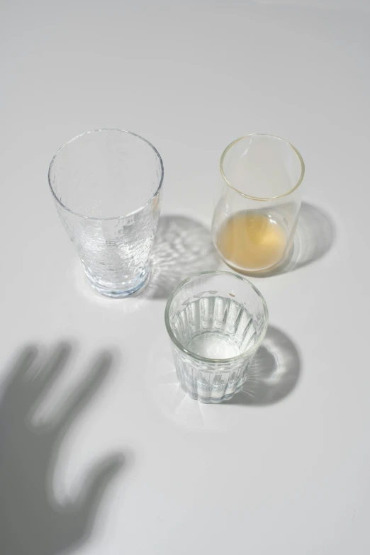 there are some glasses on the table and one is empty