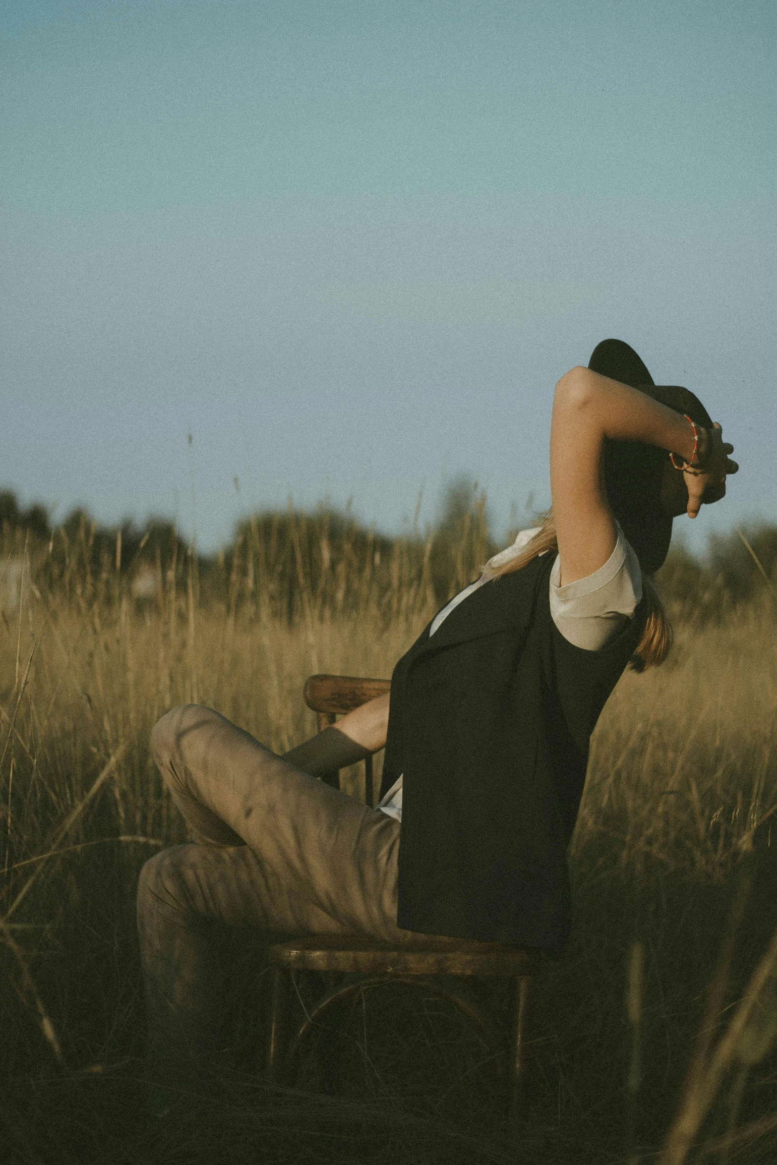 a man laying in a chair on top of a field