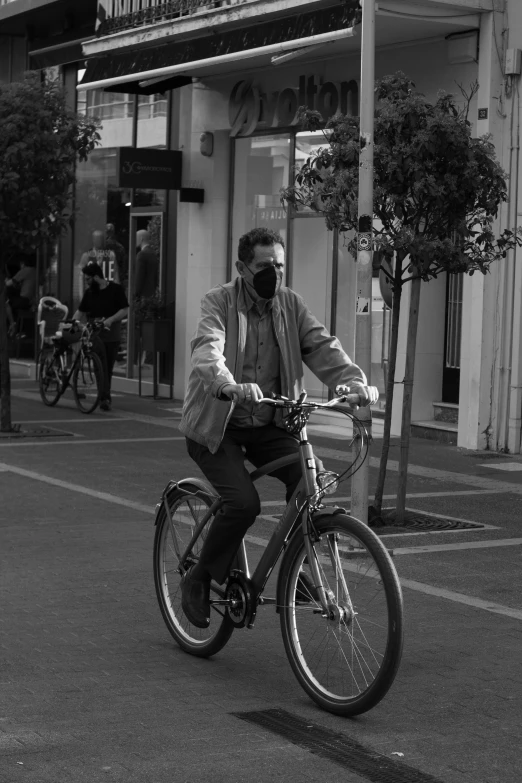 black and white pograph of person riding bike