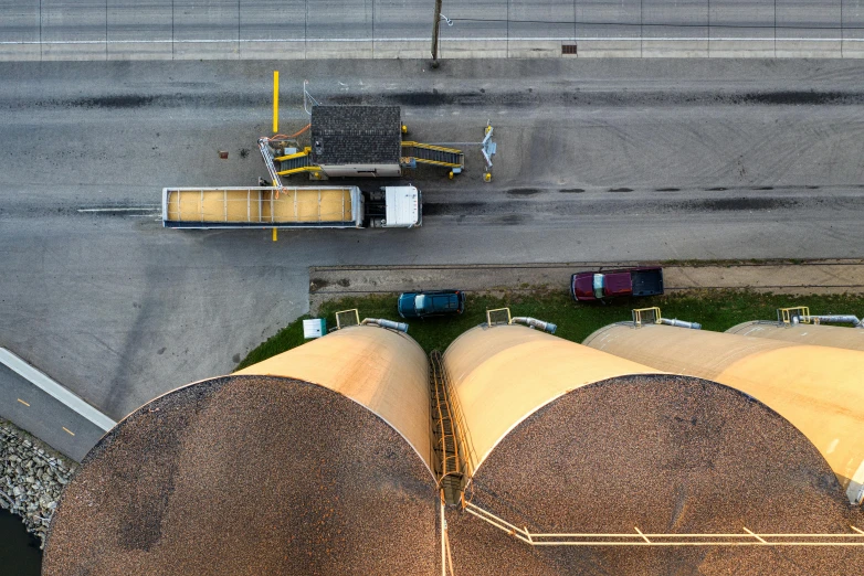 a truck parked behind several yellow pipes