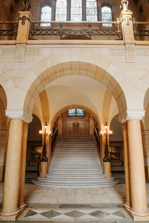 an ornate building with stairs leading to two windows