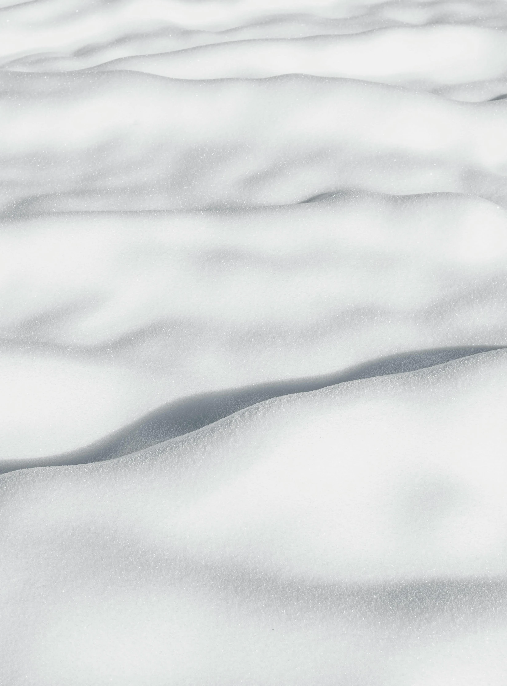 large white expanse of snow with a patch of grass