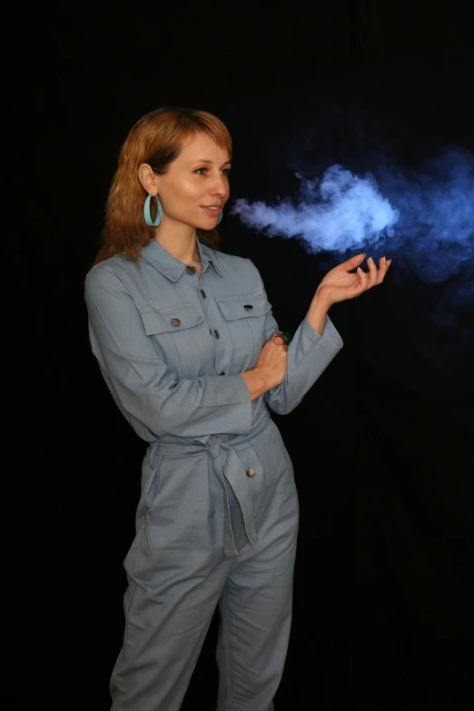 a woman with long red hair standing in front of smoke