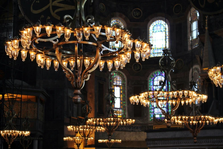 a chandelier inside of a church with lots of glass