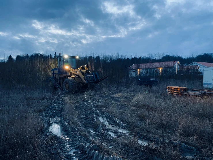 an abandoned farm tractor in the middle of a field