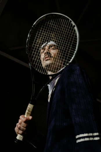 a man holding a tennis racquet with both hands