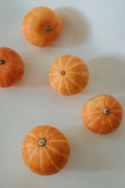 several peeled oranges laying on top of a table