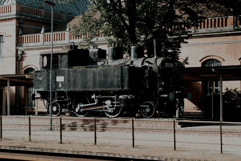 a train sitting in front of a big building