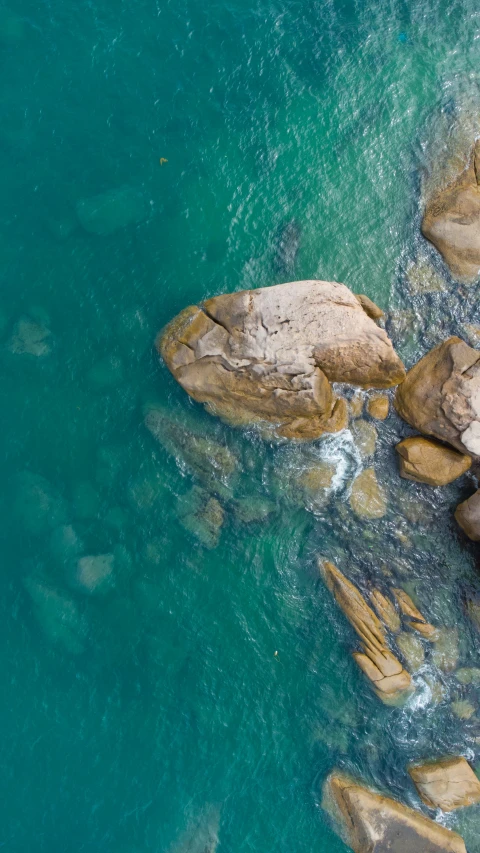 the blue water near rocks has clear blue water