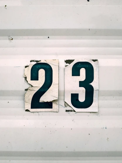 number 23 and 32 is on white painted metal