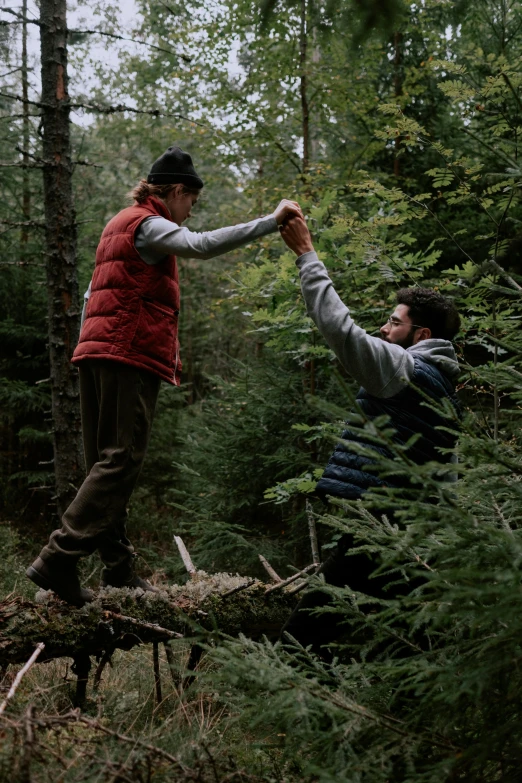 a man is attempting to scare another man from the forest