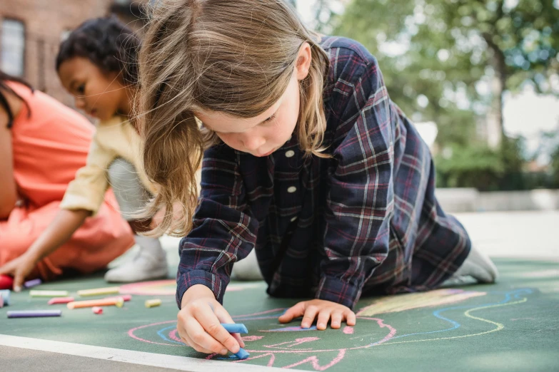 three girls are writing on a chalk board