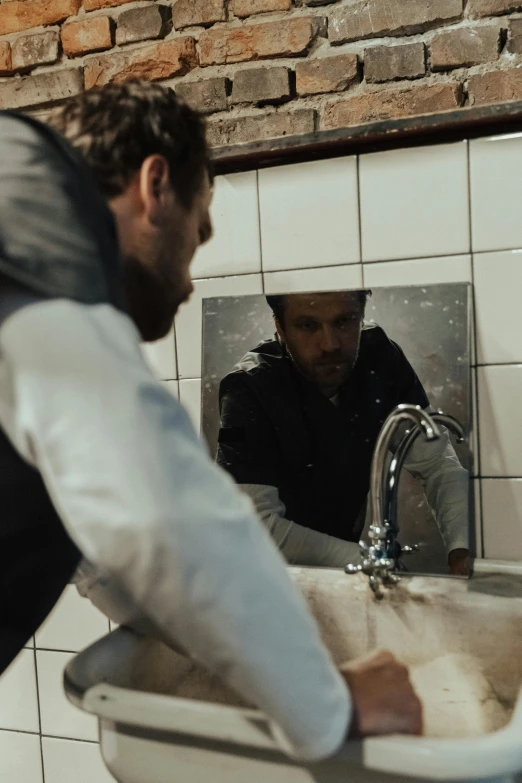 a man and woman are standing in the bathroom with a big white sink