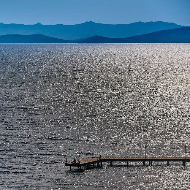 a po taken looking down on an open body of water and pier