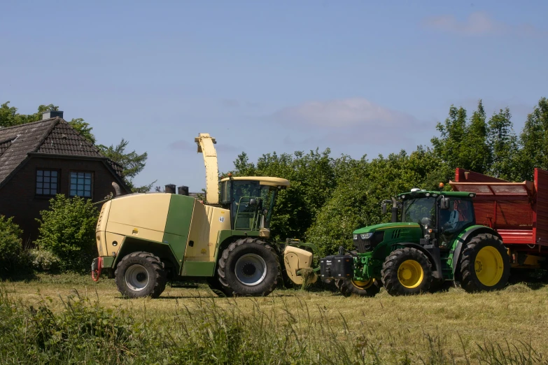 tractor trailer pulling a load of bales behind it