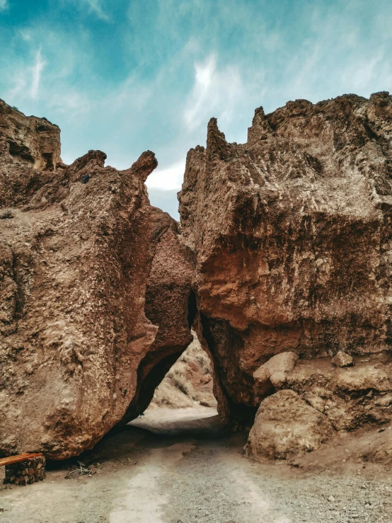 an image of a rock arch with a sky background