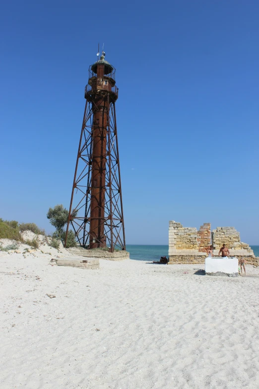 a light house sitting on top of a sandy beach