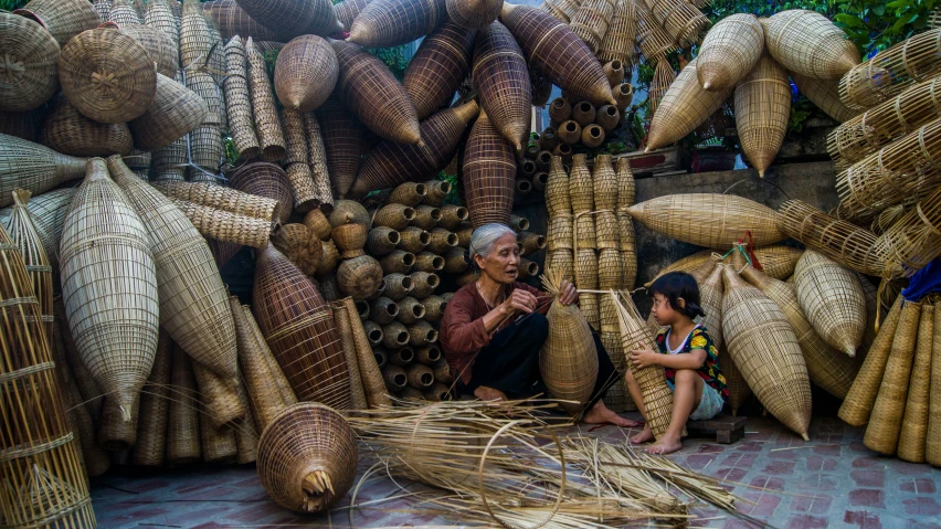 two women working together at a market selling large baskets