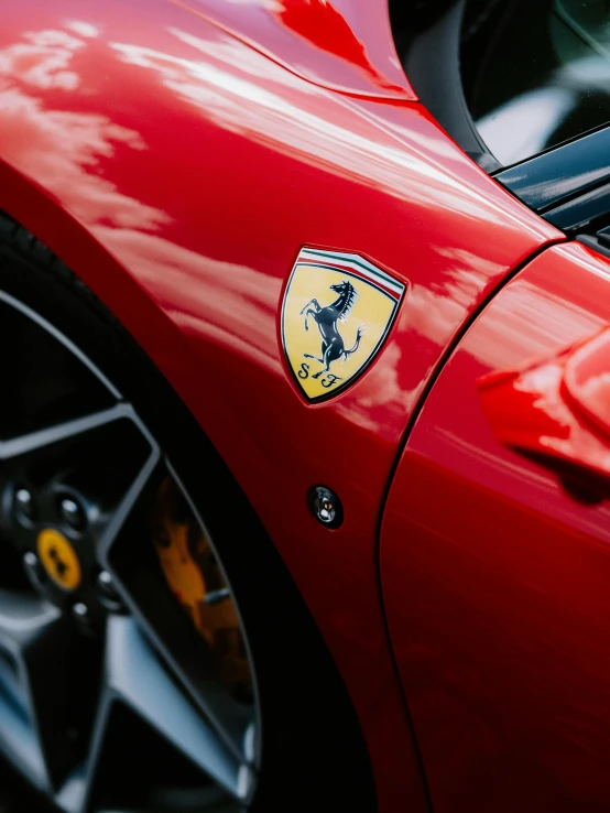 a ferrari parked next to a red one