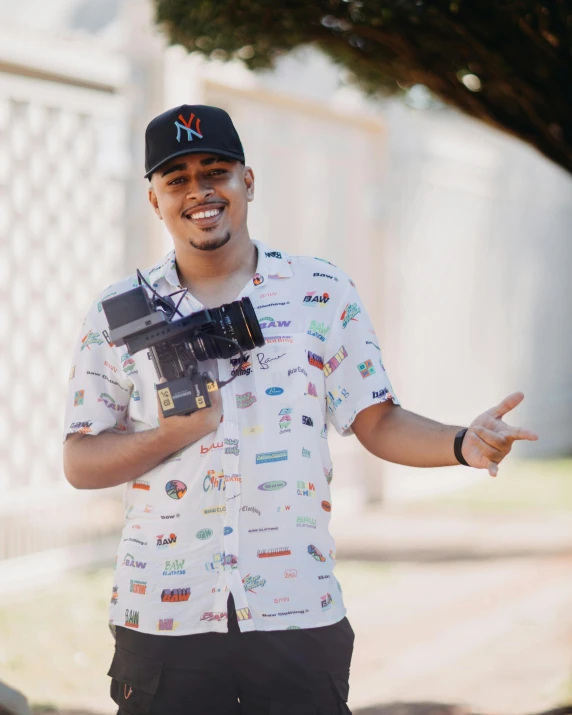 a man holding a camera and pointing at it