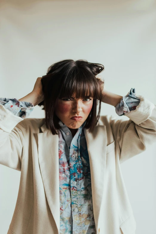 a woman standing with a messy hair comb in her hair