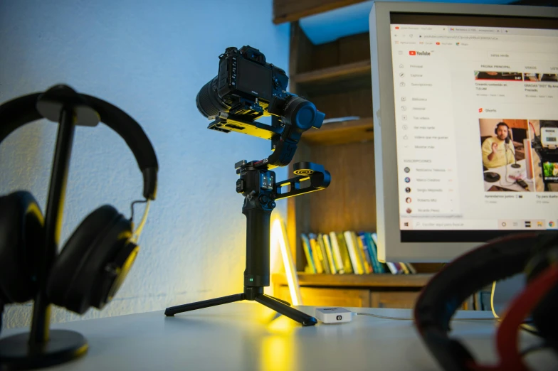 a camera sits next to an image of a screen and headphones