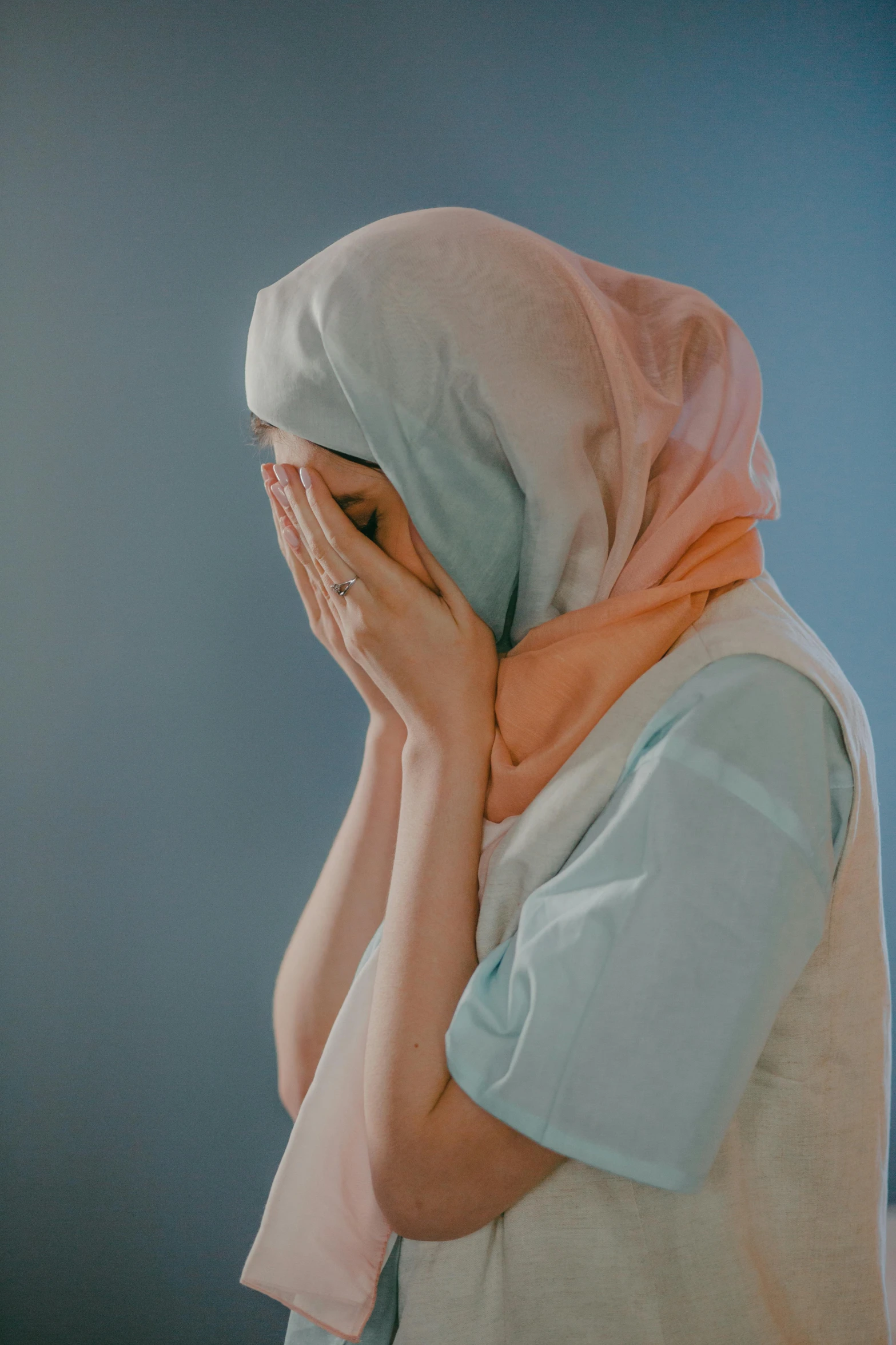 a woman covering her face with her hand