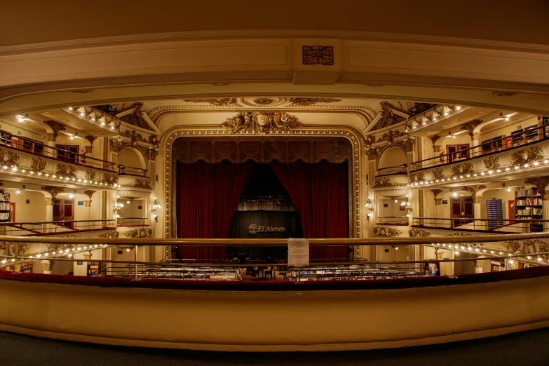 the inside of an old auditorium with red curtains