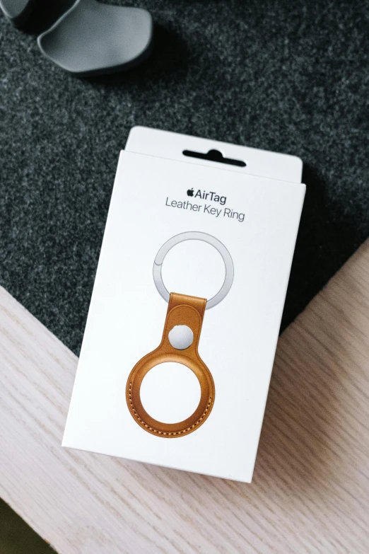 an earring made with metal and wood in its packaging