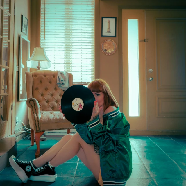 a woman sitting in a room with a record