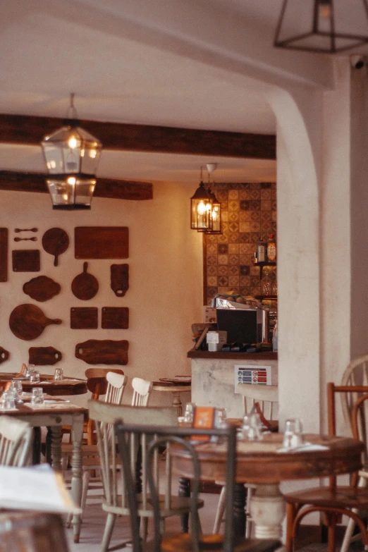 a restaurant with tables and chairs in front of wall decorations