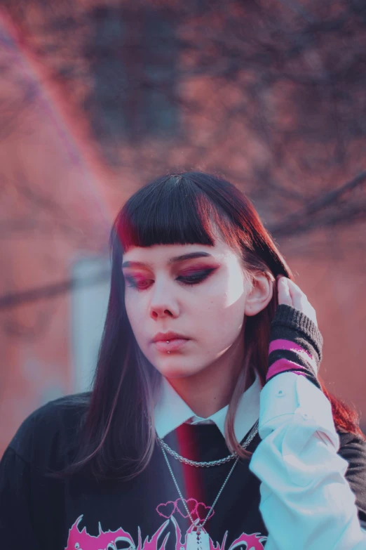 a girl in school uniform talking on her cell phone