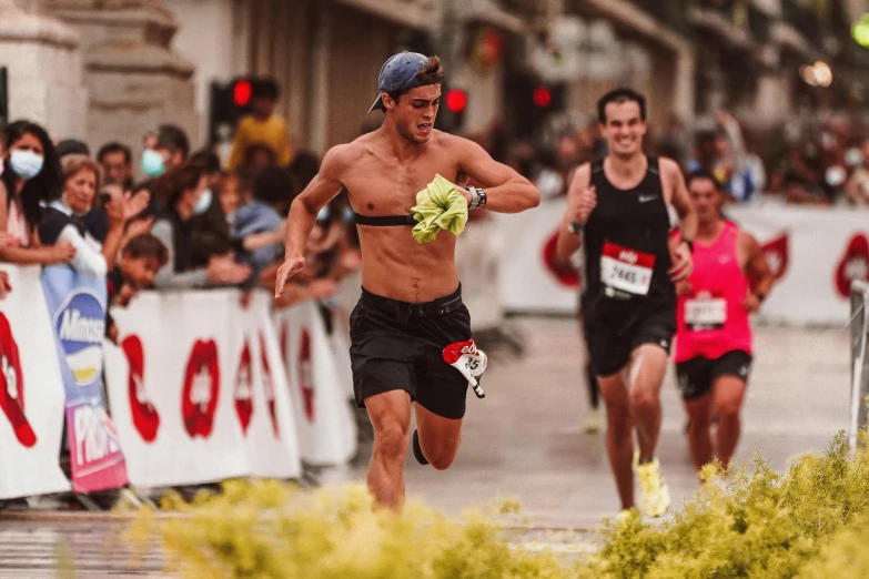 the marathon participant is running down the street