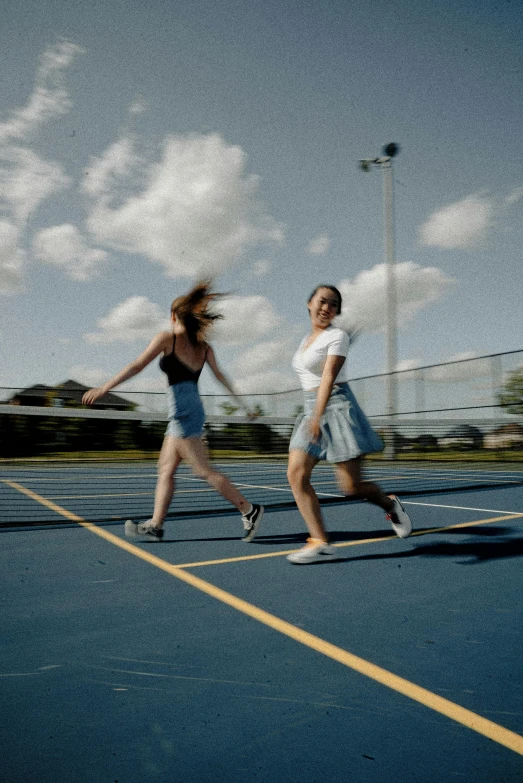 a couple of people that are standing on a tennis court