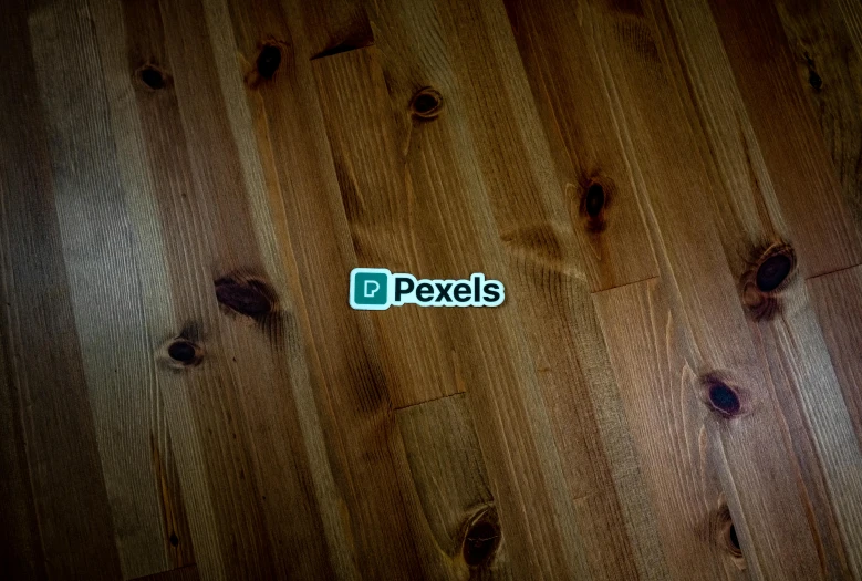 a logo is pictured on the wood floors of this room